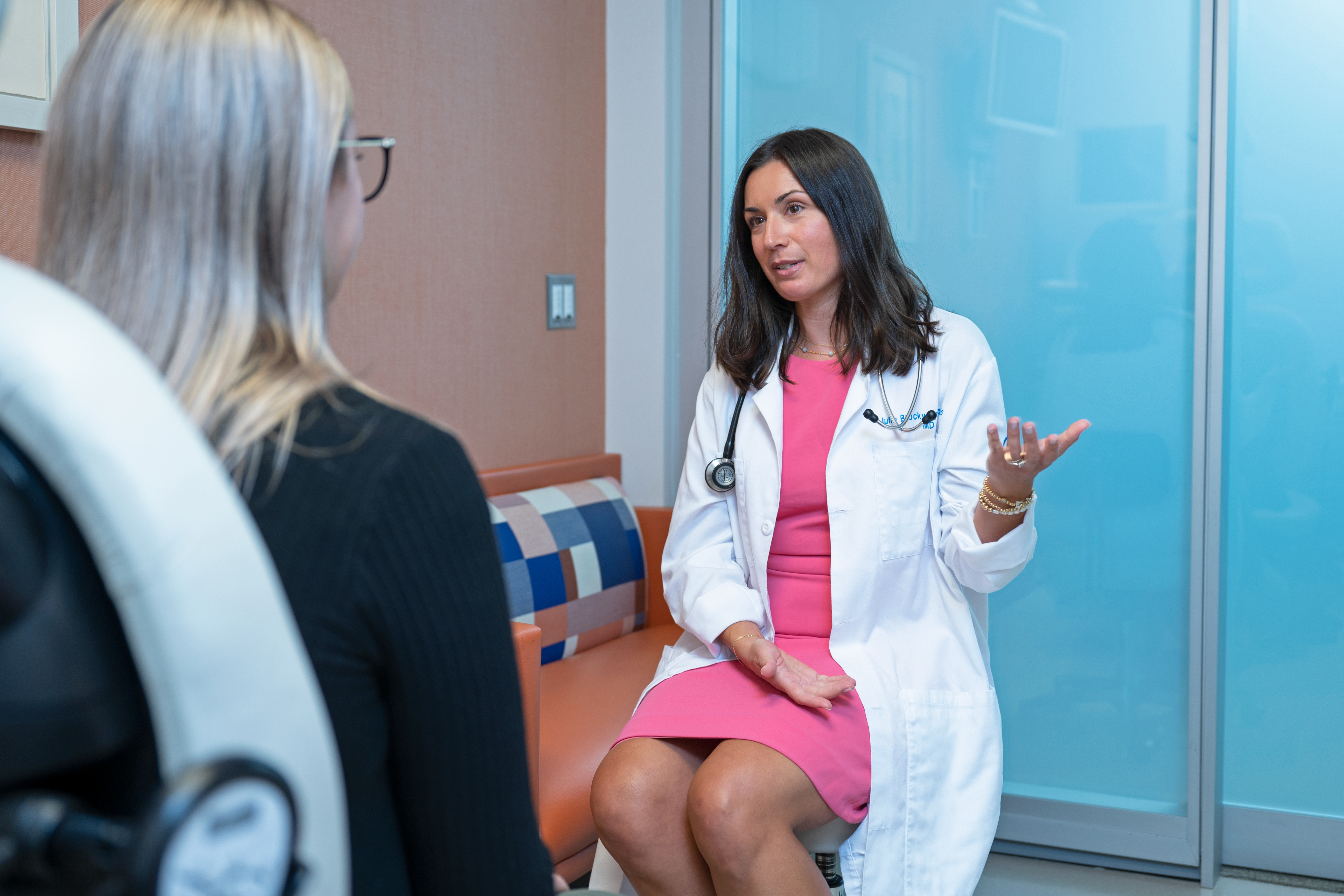 Medical oncologist Julia Brockway-Marchello talks with a patient  