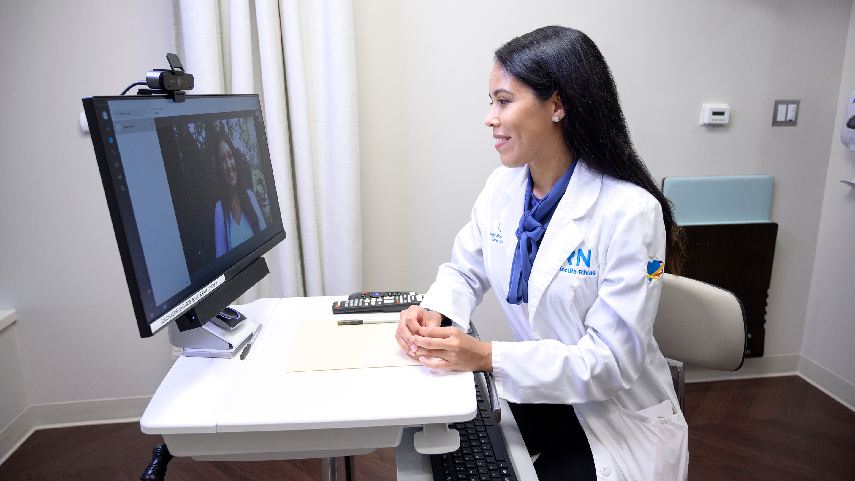 Clinical nurse Priscilla Rivas talks with a patient during a telemedicine appointment 