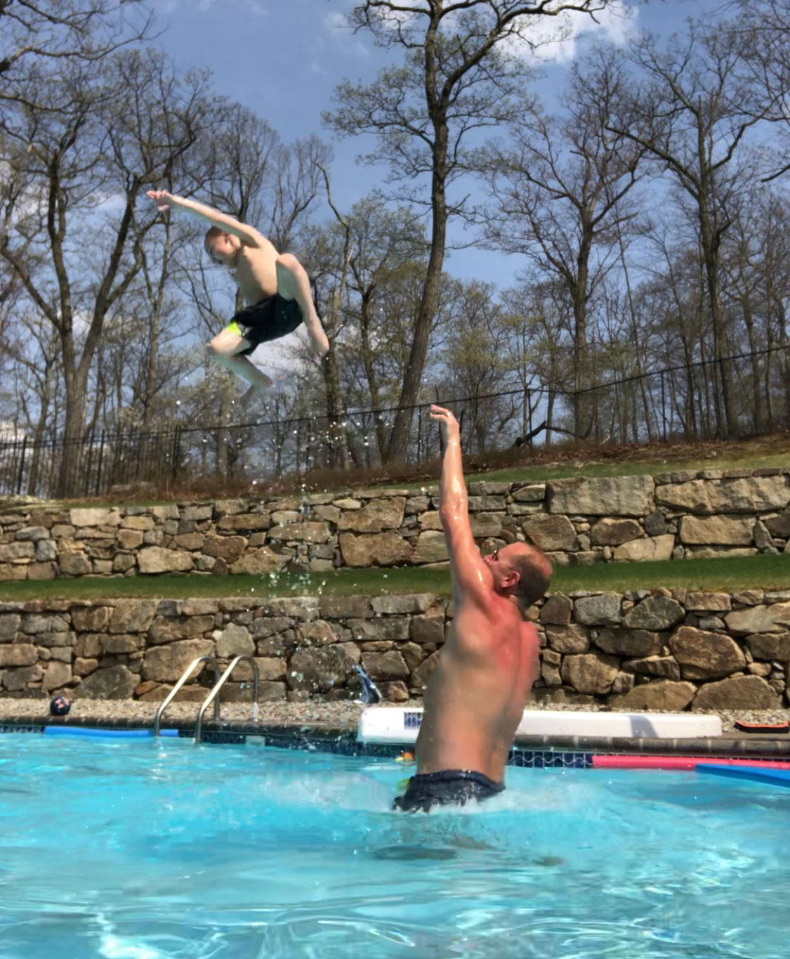 Man throws his son in the pool
