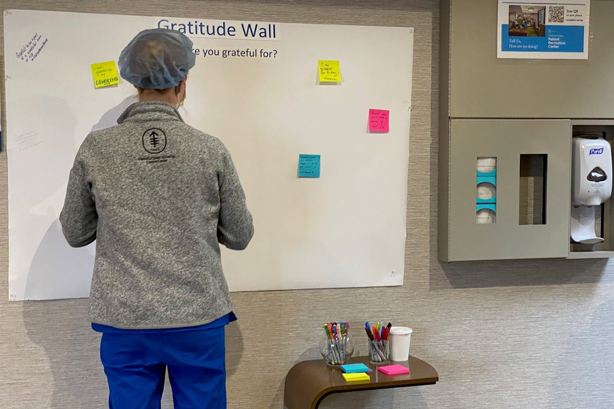 MSK employees taking a moment to share thoughts and observations on the Gratitude Wall.