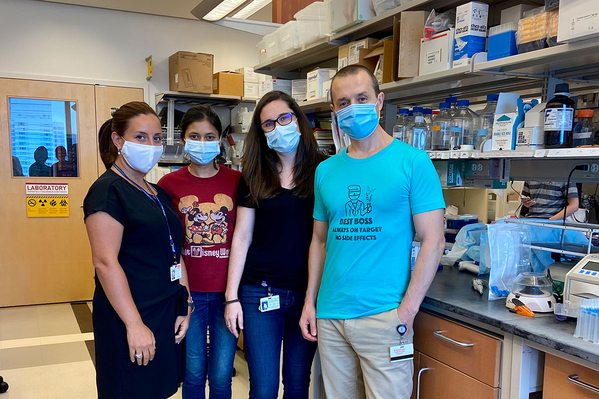 The study co-authors wearing masks and posing in the lab