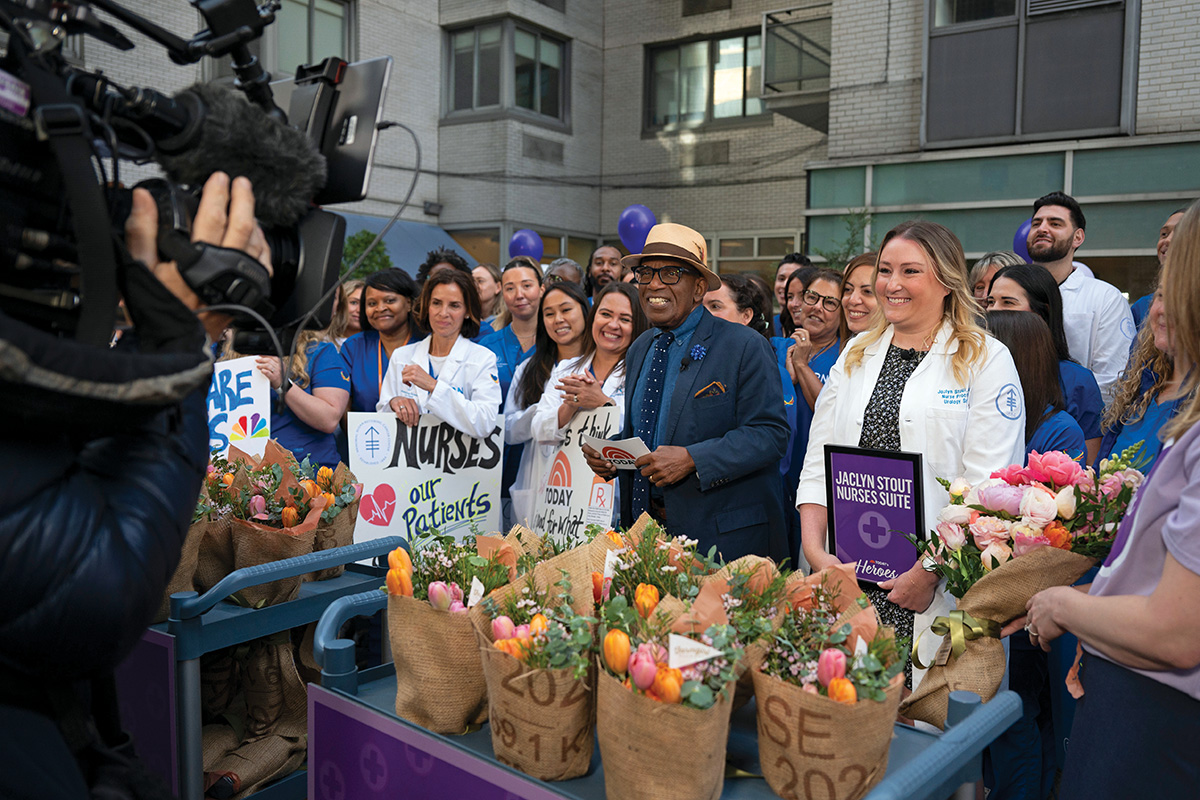 Jakki stands with Al Roker and a crowd of nurses and others.