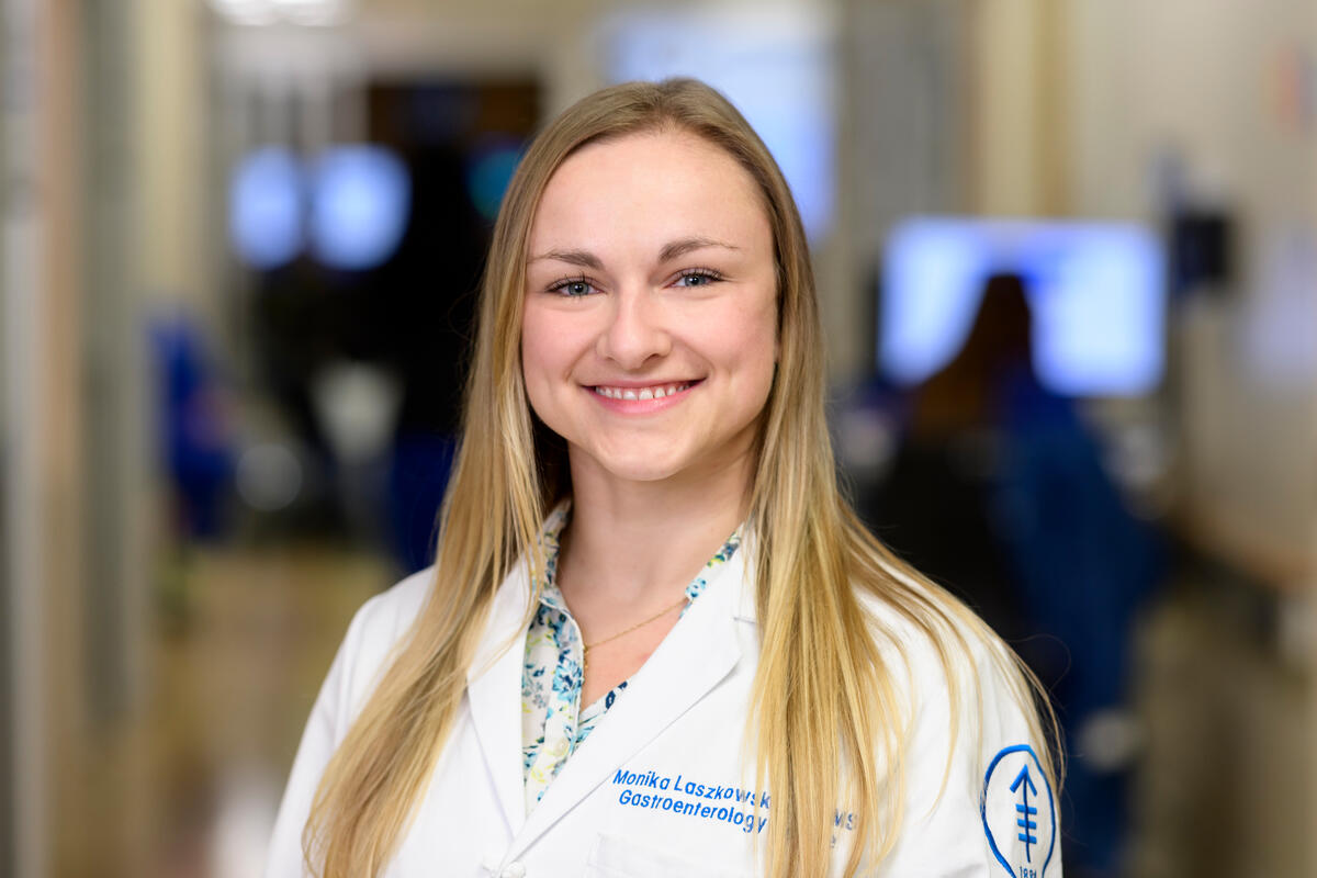 Gastroenterologist Monika Laszkowska seen smiling in hallway. 