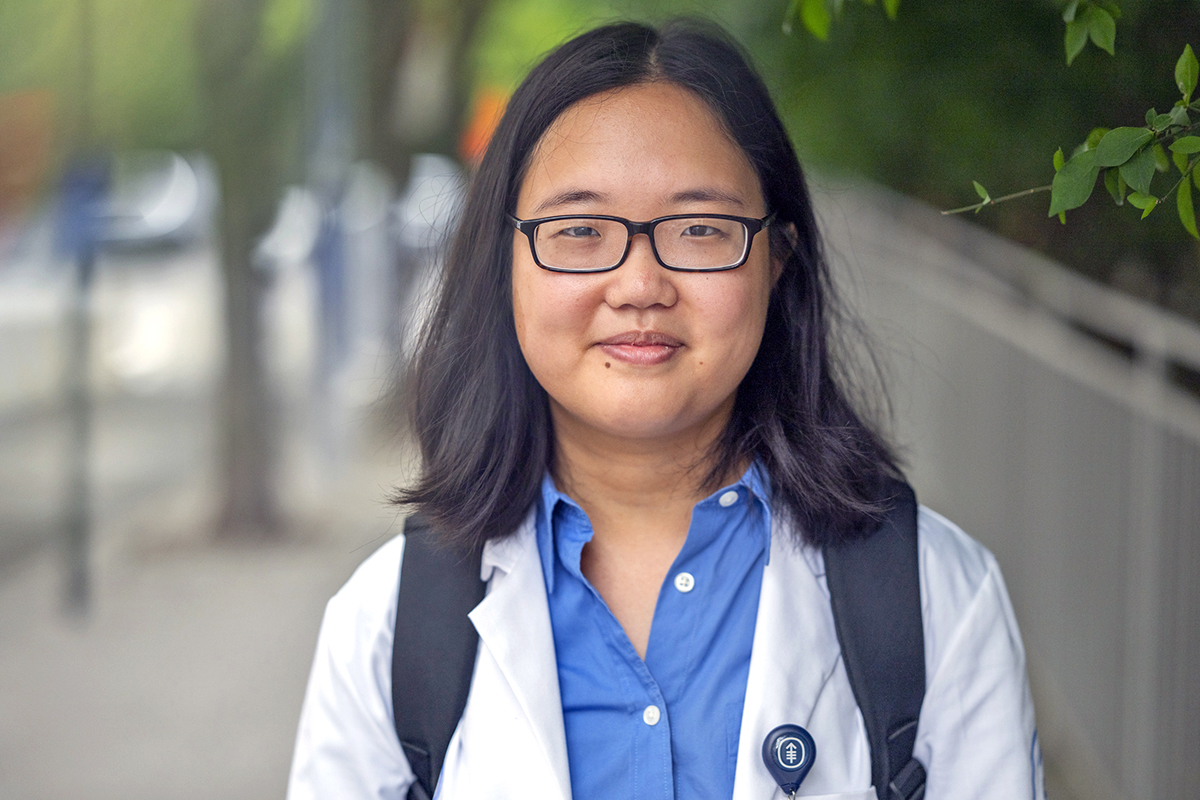 Young woman in white medical coat.