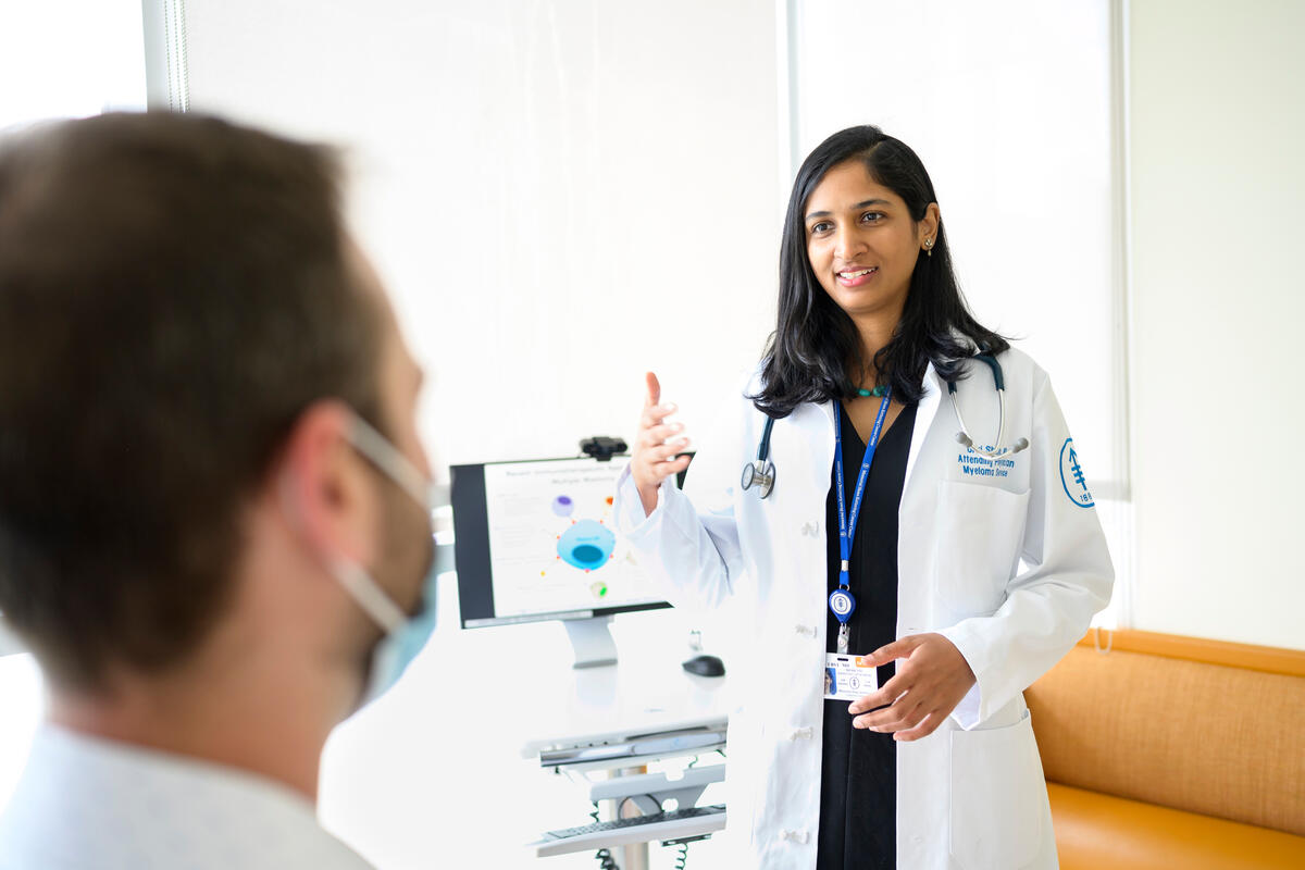 Hematologic oncologist Dr. Urvi Shah speaks to a patient at MSK.