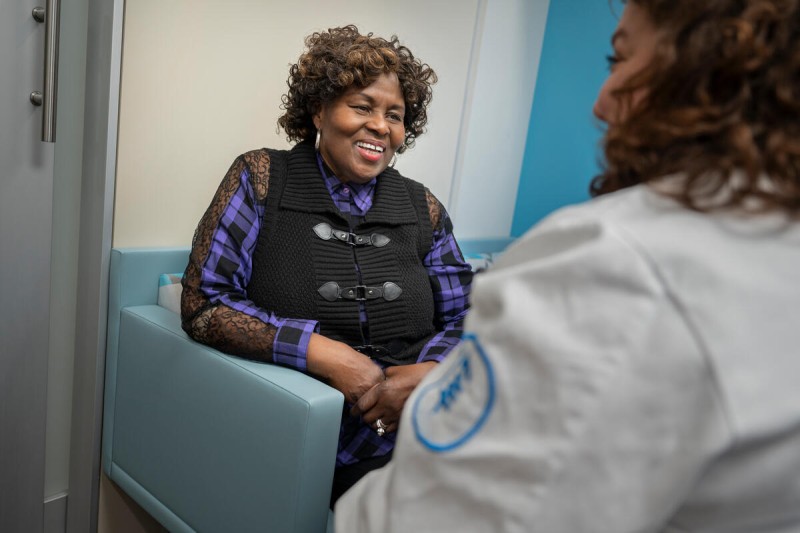 Lung cancer patient Ingrid Adams speaks with her nurse.