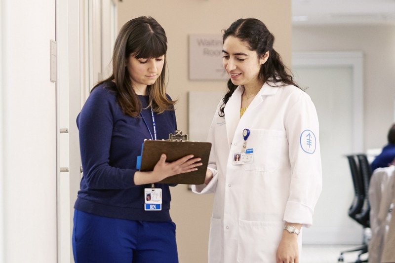 Medical oncologist, Rona Yaeger, looking at a clipboard with fellow MSK colleague