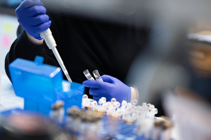 detail shot of a scientist pipetting in a lab