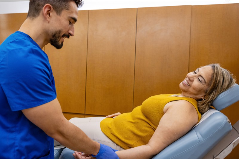 MSK acupuncturist Charles Rico is seen giving acupressure to patient Elizabeth Sosa at the MSK Ralph Lauren Center. 