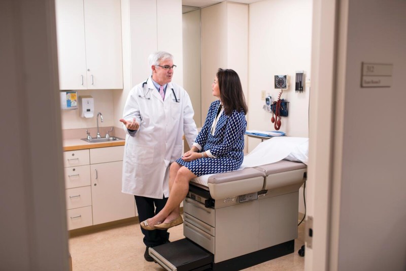 Dr. Michael Tuttle consults with a patient in an exam room