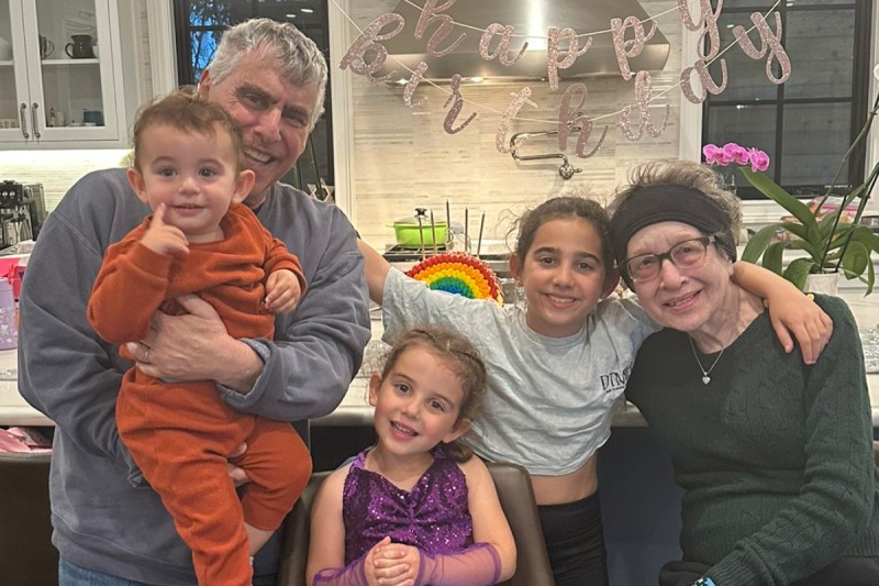 Meryl Jacobs poses with her husband and grandkids