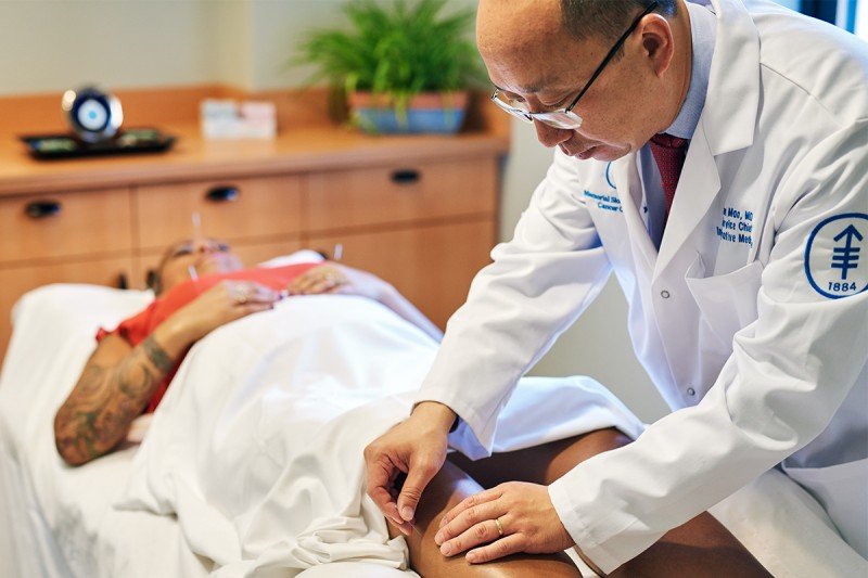 Memorial Sloan Kettering Chief of Integrative Medicine Service and acupuncture specialist Jun Mao with a patient