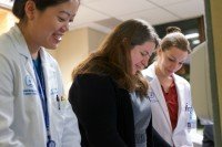 MSK physician Aimee Crago consults with two colleagues.