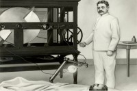 William Coley administers radiation to a patient with one of the first x-ray machines.