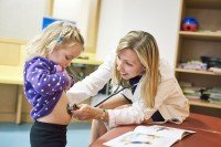 Radiation Oncologist,  Suzanne Wolden with child patient