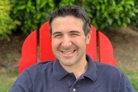 Seth Frankel sitting in a red chair