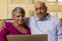 Couple looking at laptop screen together