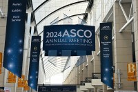 The 2024 ASCO sign hangs above a long hallway
