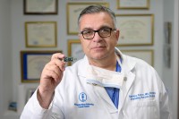 Dr. Gaetano Rocco is seen holding a component of the E-nose lung cancer test. 