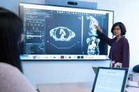 Harini Veeraraghavan stands in front of a radiology display