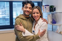 A bone marrow transplant patient at MSK Kids hugs Dr. Maria Cancio, who treated him for sickle cell disease