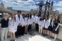 Group of diverse college students on roof of building.