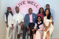 Dr. Selwyn Vickers and his wife Janice seen smiling with their four children and son-in-law. 