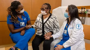 Nurses Jasmine Gibson (left) and Margaret Bediones with a patient at MSK’s Ralph Lauren Center.